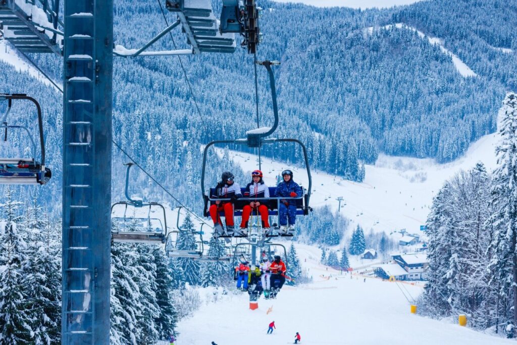 skiers on the cable car
